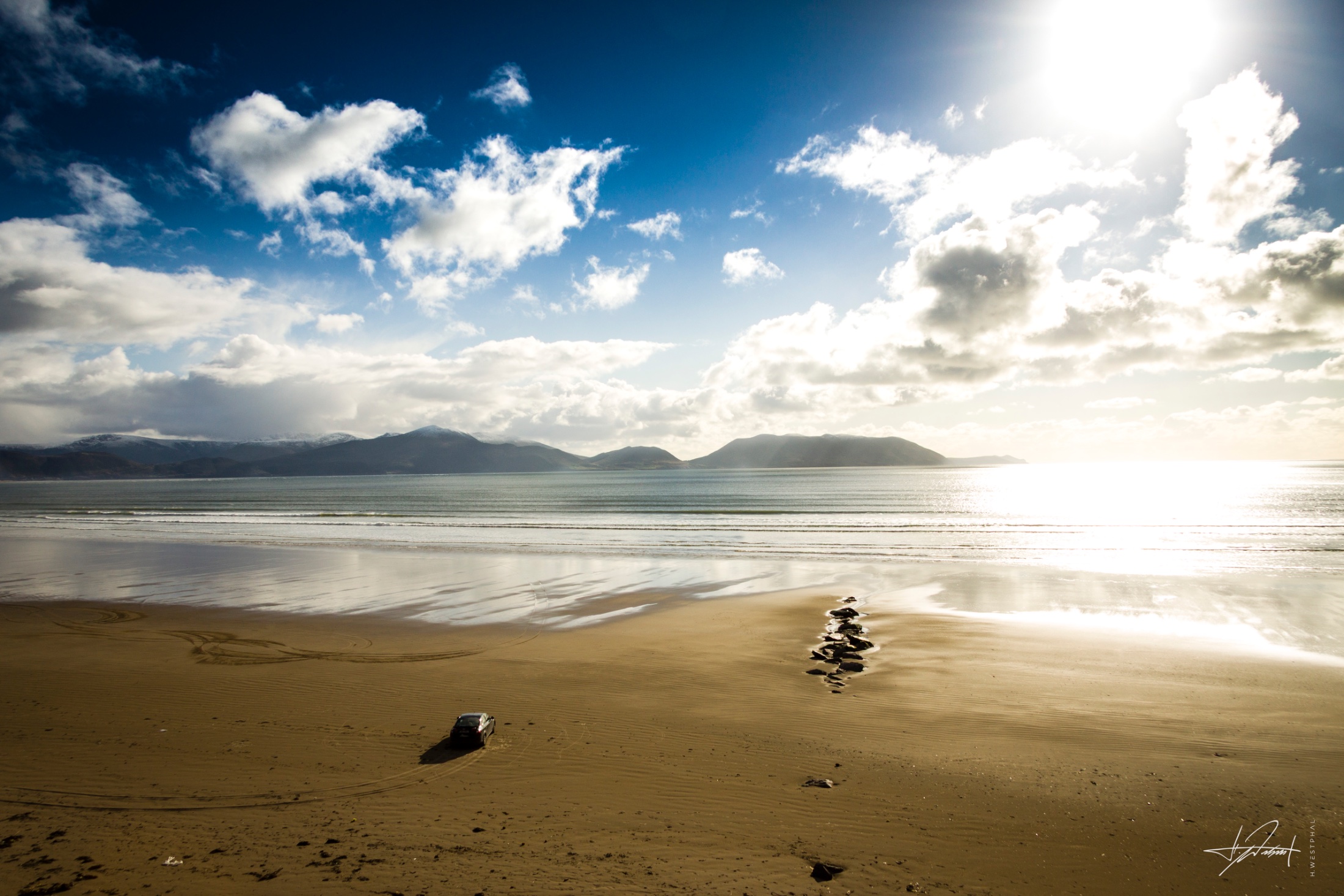 Lone car on Inch Strand, Ireland